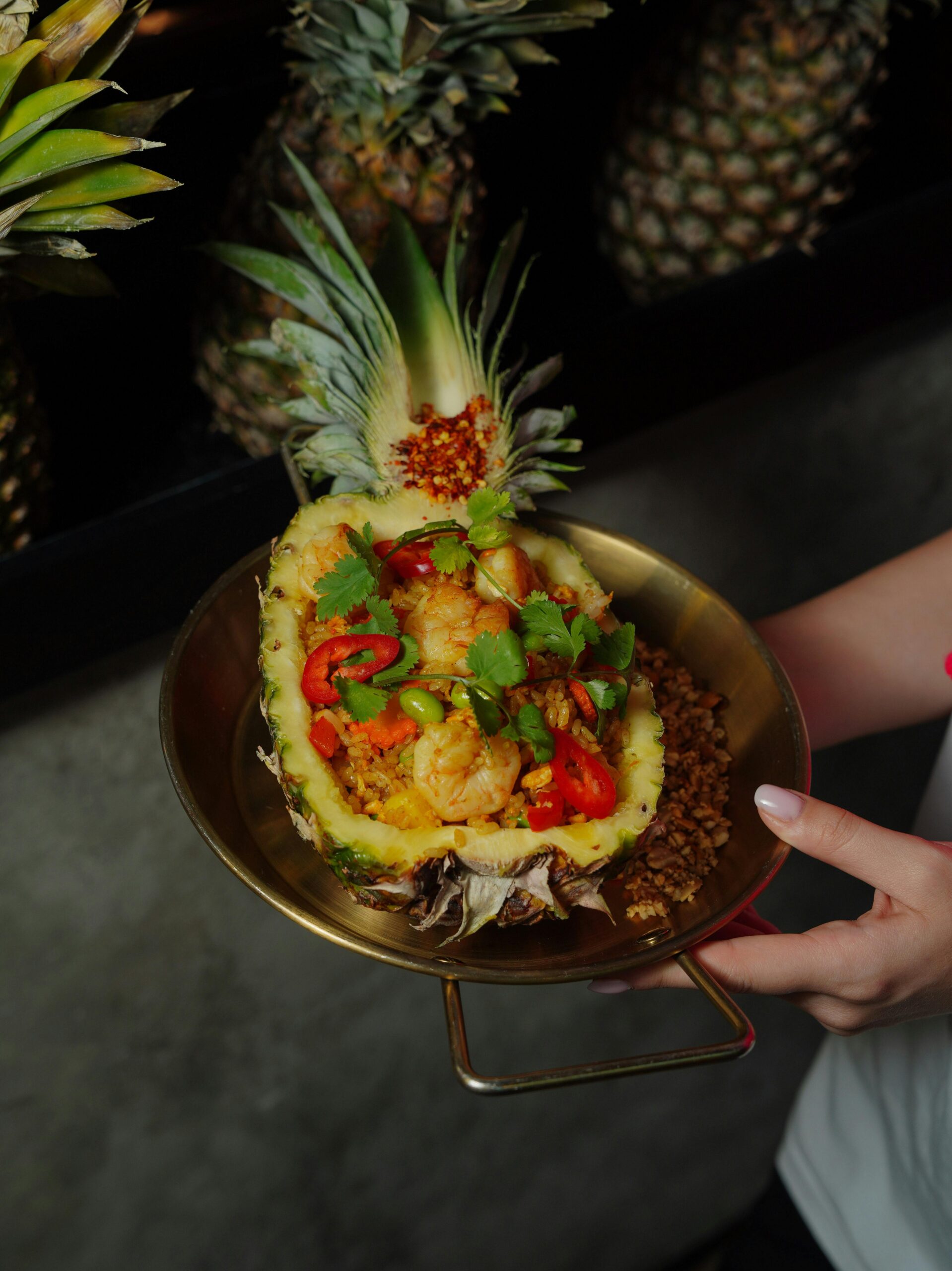 Delicious shrimp dish served in a pineapple with cilantro and peppers.